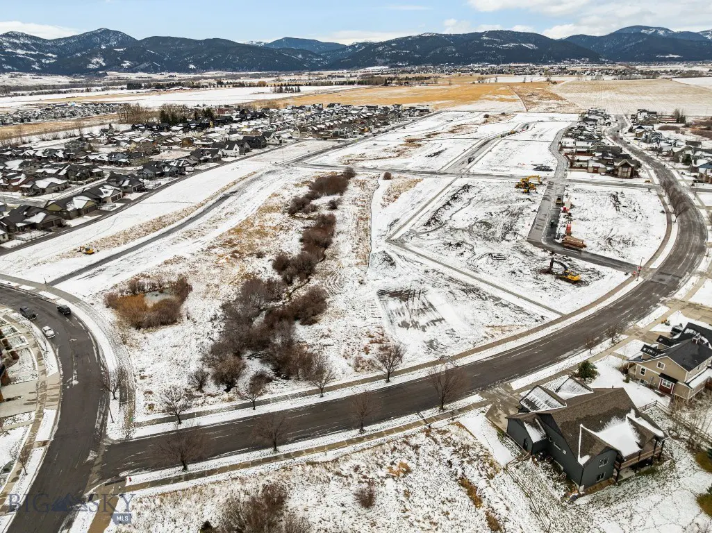 Snow-covered Meadow Bridge residential development with construction areas