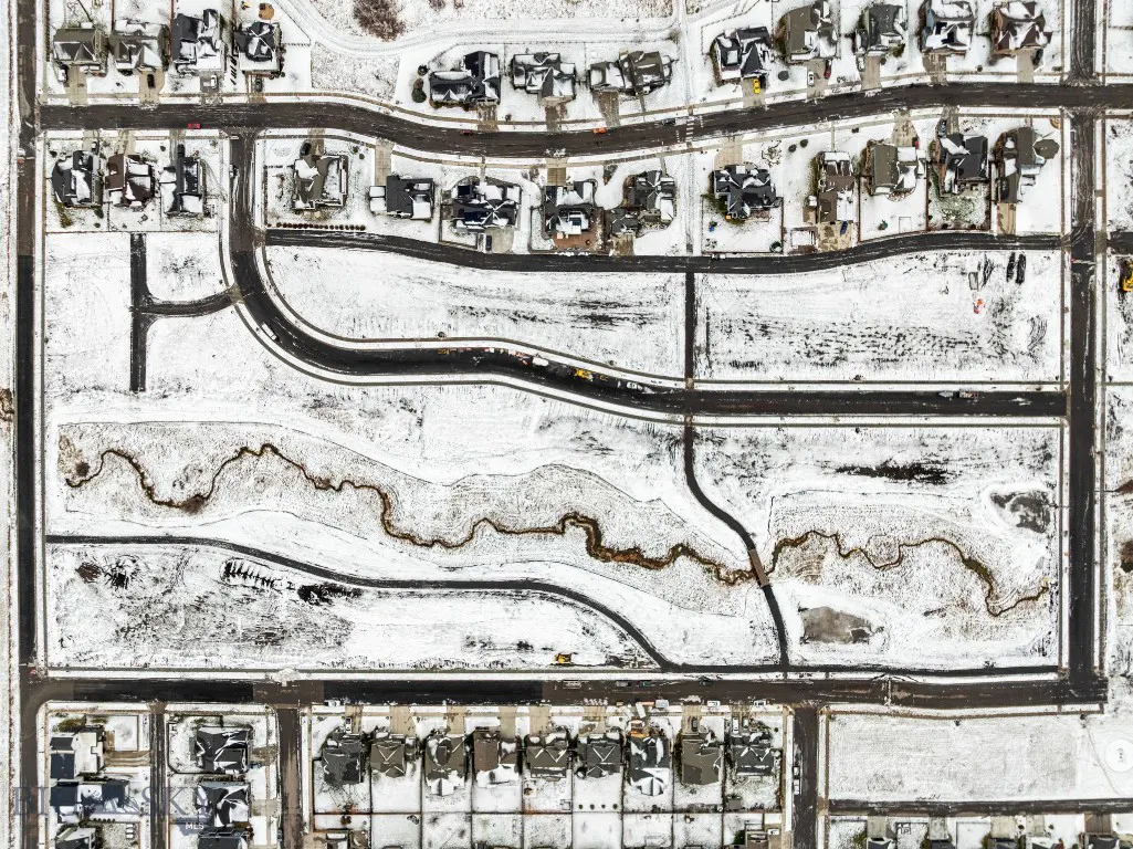 Overhead winter view of Meadow Bridge roads, lots, and creek corridor