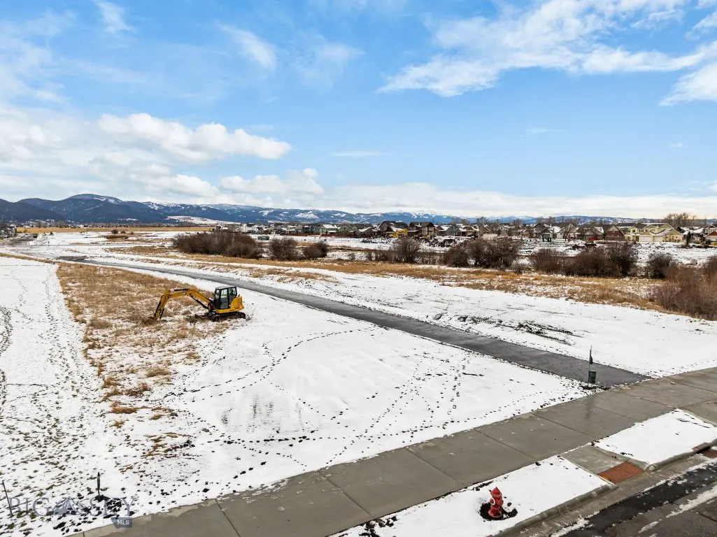 Snow-covered Meadow Bridge lot with construction equipment nearby