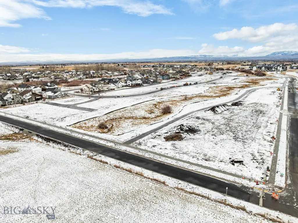 Snowy Meadow Bridge residential development with roads and mountain views